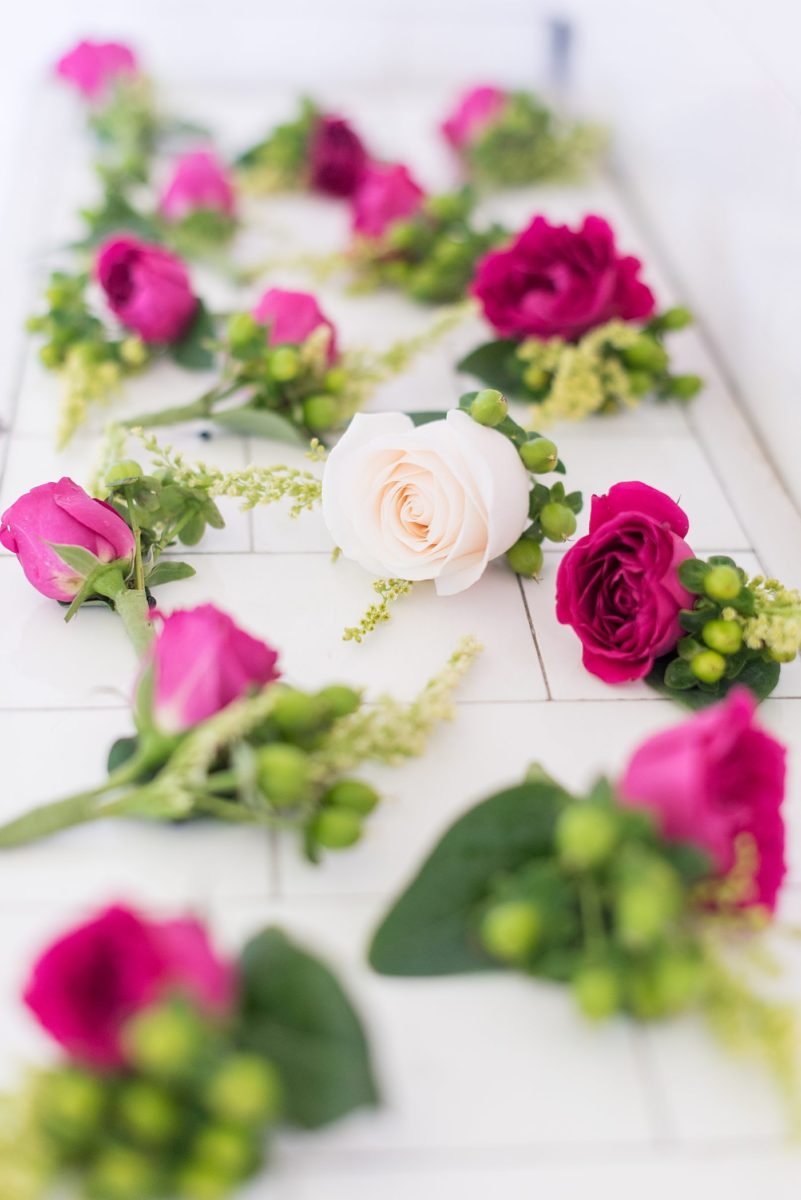 Detail photo of the groom and groomsmen rose boutonnieres by Mikkel Paige Photography. The wedding was at the Waveny House in New Canaan, Connecticut. This beautiful venue has an outdoor garden for the ceremony and indoor historic home for the wedding reception. #mikkelpaige #wavenyhouse #wavenyhousewedding #connecticutweddingvenue #connecticutweddingphotographer #gettingready #groomstyle #boutonnieres #roseboutonniere #detailshots #groomsmen