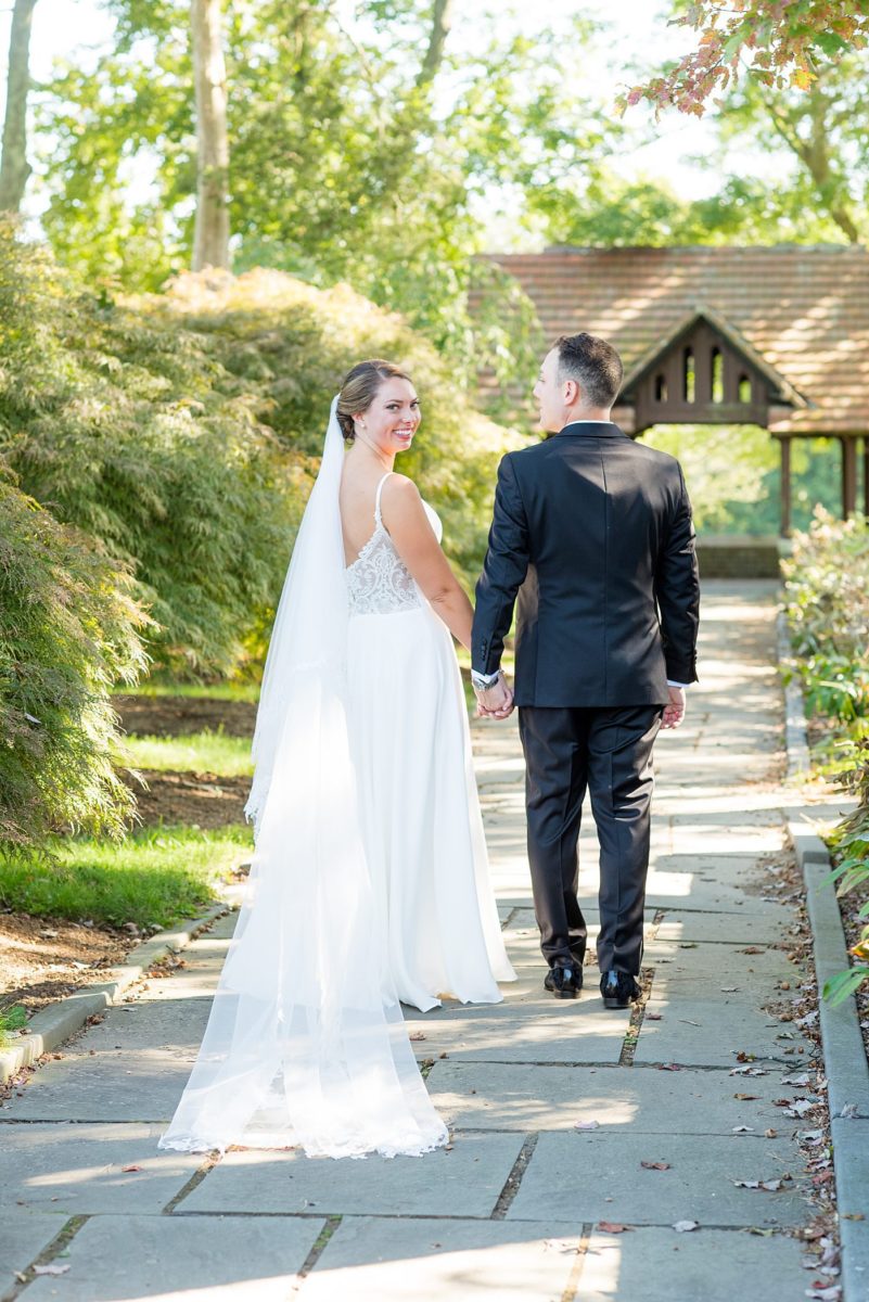 Photos by Mikkel Paige Photography at Waveny House wedding venue in New Canaan, Connecticut. This beautiful venue has an outdoor garden for the ceremony and indoor historic home for the reception. The bride and groom took photos on the park property, him in a tuxedo and her in a simple white gown with elaborate lace back. She carried an all white and ivory bouquet. #mikkelpaige #wavenyhouse #wavenyhousewedding #connecticutweddingvenue #connecticutweddingphotographer #brideandgroom #whitebouquet