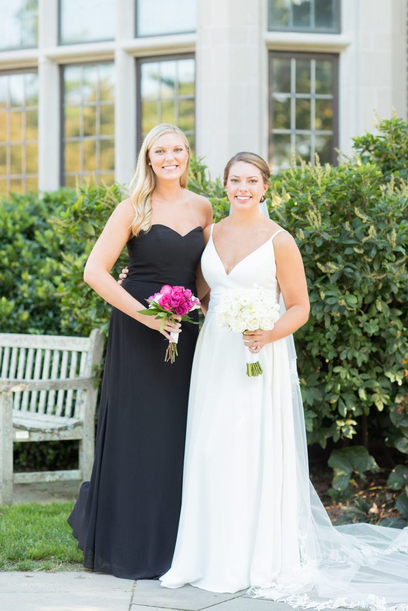 Bridal party photos by Mikkel Paige Photography at Waveny House wedding venue in New Canaan, Connecticut. This beautiful venue has an outdoor garden for the ceremony and indoor historic home for the reception. The bride wore an elegant, simple white gown and bridesmaids wore black dresses, with hot pink rose bouquets. #mikkelpaige #wavenyhouse #wavenyhousewedding #connecticutweddingvenue #connecticutweddingphotographer #bridalparty #bridesmaids #blackgowns #pinkbouquets