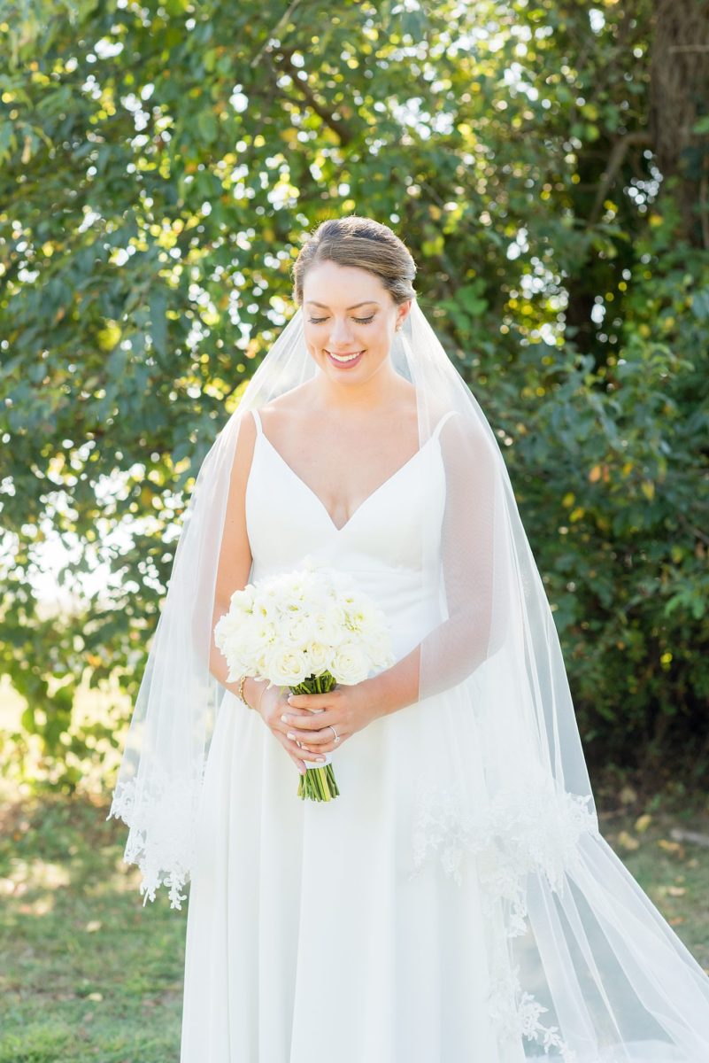 Photos by Mikkel Paige Photography at Waveny House wedding venue in New Canaan, Connecticut. This beautiful venue has an outdoor garden for the ceremony and indoor historic home for the reception. The bride wore a simple white gown with elaborate lace back. She carried an all white and ivory bouquet. #mikkelpaige #wavenyhouse #wavenyhousewedding #connecticutweddingvenue #connecticutweddingphotographer #bridestyle #whitebouquet #bridalportraits