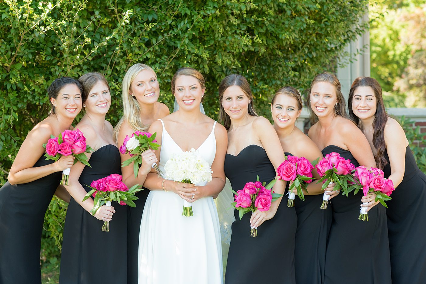 Bridal party photos by Mikkel Paige Photography at Waveny House wedding venue in New Canaan, Connecticut. This beautiful venue has an outdoor garden for the ceremony and indoor historic home for the reception. The bride wore an elegant, simple white gown and bridesmaids wore black dresses, with hot pink rose bouquets. #mikkelpaige #wavenyhouse #wavenyhousewedding #connecticutweddingvenue #connecticutweddingphotographer #bridalparty #bridesmaids #blackgowns #pinkbouquets