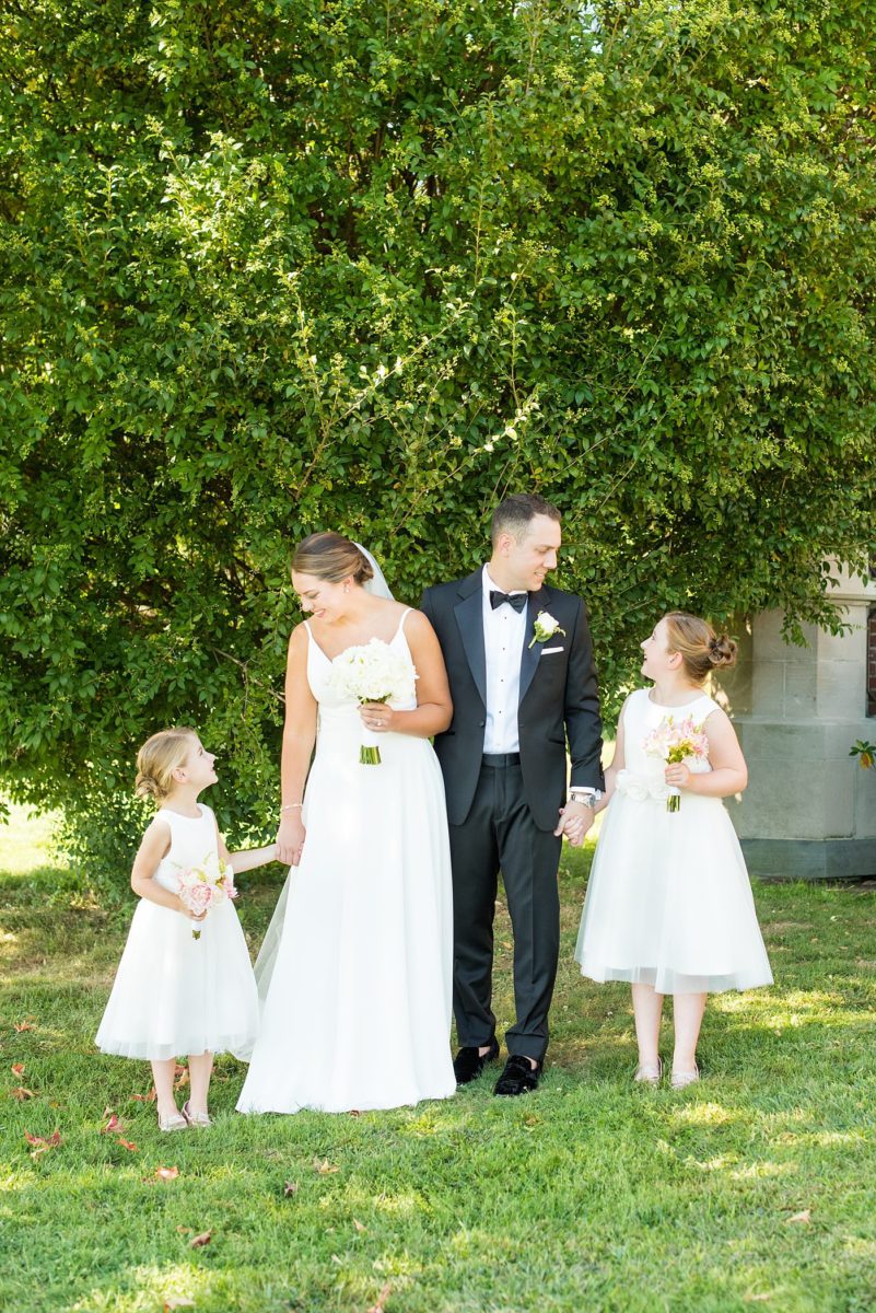 Photos by Mikkel Paige Photography at Waveny House wedding venue in New Canaan, Connecticut. This beautiful venue has an outdoor garden for the ceremony and indoor historic home for the reception. The bride and groom took photos outside with their flower girls. #mikkelpaige #wavenyhouse #wavenyhousewedding #connecticutweddingvenue #connecticutweddingphotographer #bridalparty #flowergirls