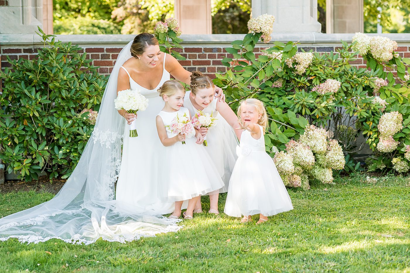 Photos by Mikkel Paige Photography at Waveny House wedding venue in New Canaan, Connecticut. This beautiful venue has an outdoor garden for the ceremony and indoor historic home for the reception. The bride and groom took photos outside with their flower girls. #mikkelpaige #wavenyhouse #wavenyhousewedding #connecticutweddingvenue #connecticutweddingphotographer #bridalparty #flowergirls