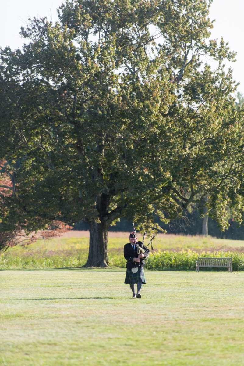 Bagpiper photo by Mikkel Paige Photography at a Waveny House wedding venue in New Canaan, Connecticut. This beautiful venue has an outdoor garden for the ceremony and indoor historic home for the reception. This was a surprise gift to the bride to honor her grandparents' family Irish heritage. #mikkelpaige #wavenyhouse #wavenyhousewedding #connecticutweddingvenue #connecticutweddingphotographer #weddingreception #cocktailhour #outdoorwedding #historichomewedding #bagpipes #Irishweddingtraditions