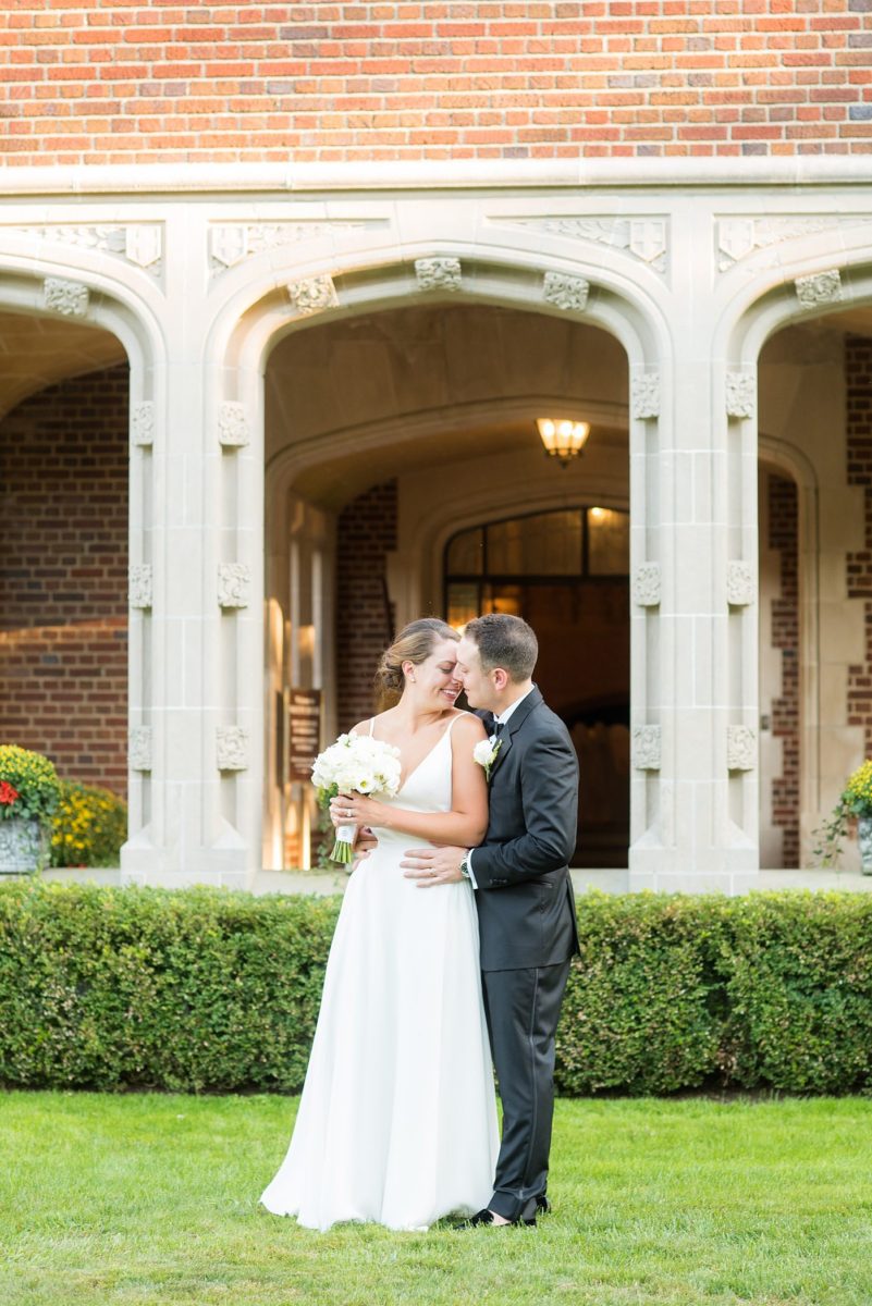 Photos by Mikkel Paige Photography at Waveny House wedding venue in New Canaan, Connecticut. This beautiful venue has an outdoor garden for the ceremony and indoor historic home for the reception. The bride and groom took photos on the park property, him in a tuxedo and her in a simple white gown with elaborate lace back. She carried an all white and ivory bouquet. #mikkelpaige #wavenyhouse #wavenyhousewedding #connecticutweddingvenue #connecticutweddingphotographer #brideandgroom #whitebouquet