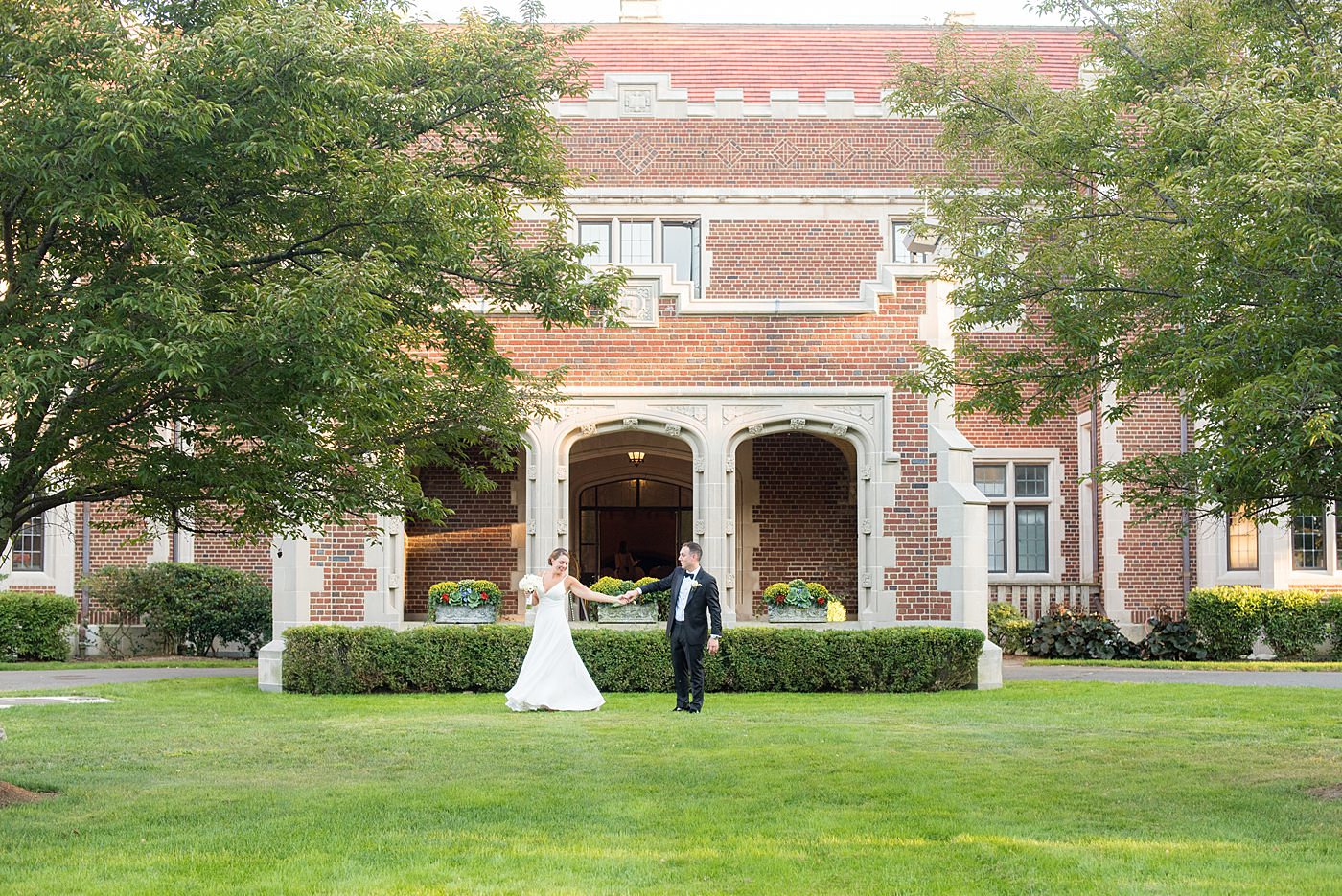 Photos by Mikkel Paige Photography at Waveny House wedding venue in New Canaan, Connecticut. This beautiful venue has an outdoor garden for the ceremony and indoor historic home for the reception. The bride and groom took photos on the park property, him in a tuxedo and her in a simple white gown with elaborate lace back. She carried an all white and ivory bouquet. #mikkelpaige #wavenyhouse #wavenyhousewedding #connecticutweddingvenue #connecticutweddingphotographer #brideandgroom #whitebouquet