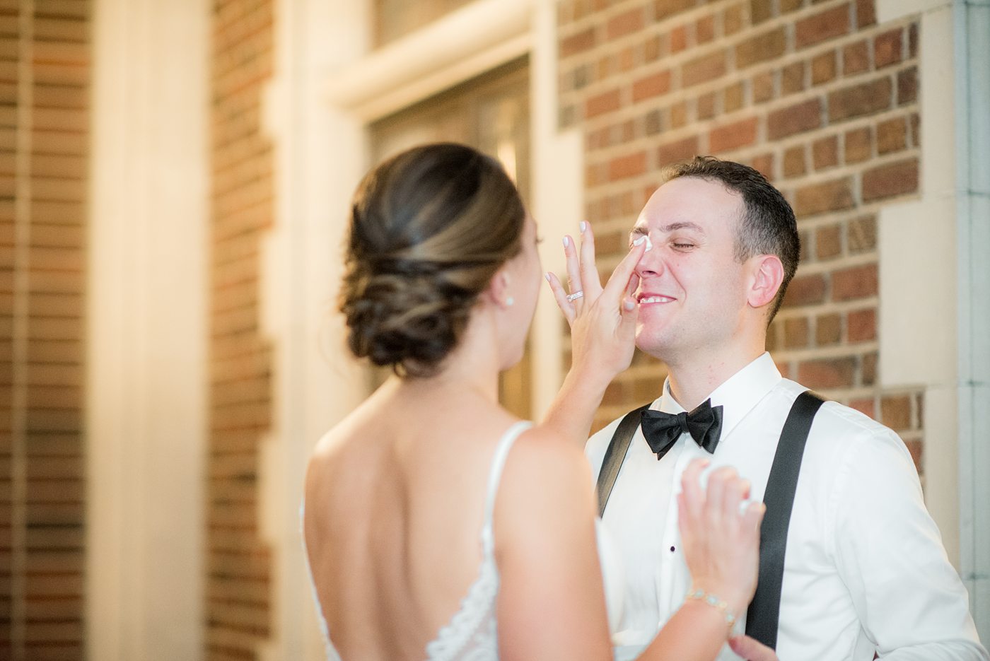 Waveny House wedding venue in New Canaan, Connecticut. Photos by Mikkel Paige Photography. This beautiful venue has an outdoor garden for the ceremony and indoor historic home for the reception. The bride and groom cut their three tier white buttercream wedding cake on the outside patio. #mikkelpaige #wavenyhouse #wavenyhousewedding #connecticutweddingvenue #connecticutweddingphotographer #weddingcake #cakecutting