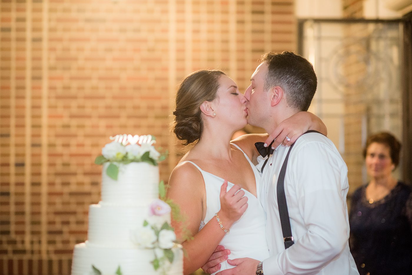 Waveny House wedding venue in New Canaan, Connecticut. Photos by Mikkel Paige Photography. This beautiful venue has an outdoor garden for the ceremony and indoor historic home for the reception. The bride and groom cut their three tier white buttercream wedding cake on the outside patio. #mikkelpaige #wavenyhouse #wavenyhousewedding #connecticutweddingvenue #connecticutweddingphotographer #weddingcake #cakecutting