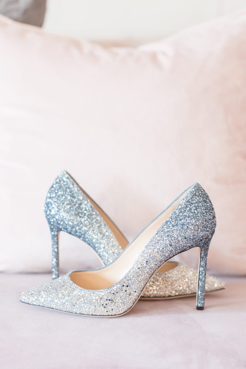 Detail photo of the bride's wedding day blue ombre glitter Jimmy Choo shoes at Chatham Station by Mikkel Paige Photography. This beautiful Cary, North Carolina venue has indoor and outdoor spaces. #mikkelpaige #RaleighWeddingPhotographer #NorthCarolinaWeddings #SouthernWeddings #bridestyle #weddingshoes #blueglitterheels #glittershoes #blueombre #ombreshoes