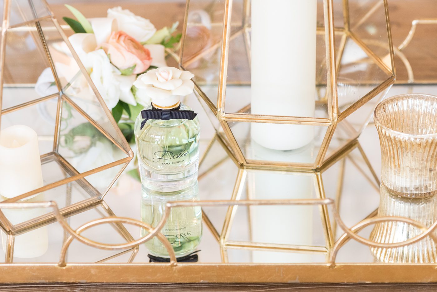 Detail photo of the bride's wedding day perfume at Chatham Station by Mikkel Paige Photography. This beautiful Cary, North Carolina venue has indoor and outdoor spaces. #mikkelpaige #RaleighWeddingPhotographer #NorthCarolinaWeddings #SouthernWeddings #bridestyle #weddingperfume #weddingdetails