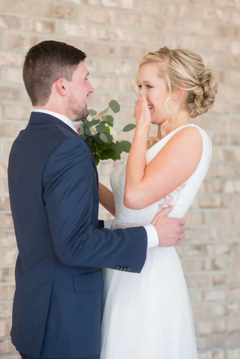 Chatham Station wedding photos by Mikkel Paige Photography from this urban chic beautiful venue in Cary, North Carolina. The bride wore a white tulle v-neck gown and up hair-do with braids and groom a blue suit with custom details for a fall celebration. #mikkelpaige #RaleighWeddingPhotographer #NorthCarolinaWeddings #SouthernWeddings #bridestyle #brideandgroom