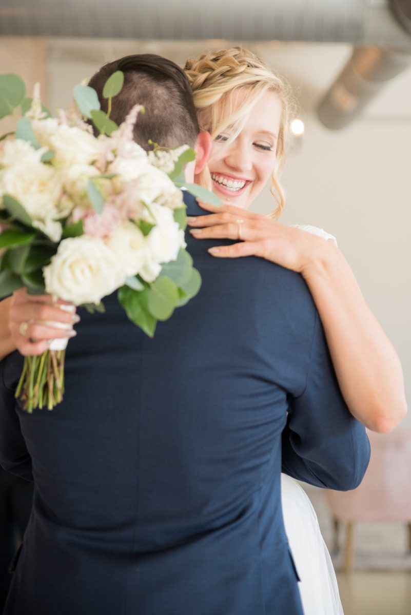 Chatham Station wedding photos by Mikkel Paige Photography from this urban chic beautiful venue in Cary, North Carolina. The bride wore a white tulle v-neck gown and up hair-do with braids and groom a blue suit with custom details for a fall celebration. #mikkelpaige #RaleighWeddingPhotographer #NorthCarolinaWeddings #SouthernWeddings #bridestyle #brideandgroom