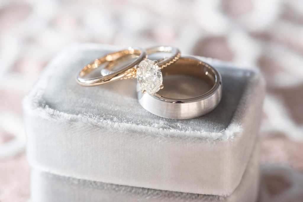 Detail photo of gold diamond rings on a blue velvet ring box at Chatham Station by Mikkel Paige Photography. This beautiful Cary, North Carolina venue has indoor and outdoor spaces. #mikkelpaige #RaleighWeddingPhotographer #NorthCarolinaWeddings #SouthernWeddings #weddingrings #velvetringbox