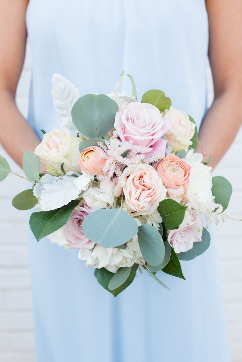 Chatham Station wedding photos by Mikkel Paige Photography from this urban chic beautiful venue in Cary, North Carolina. The bridesmaids wore light blue gowns and held bouquets of eucalyptus and pink and orange roses for a fall celebration. #mikkelpaige #RaleighWeddingPhotographer #NorthCarolinaWeddings #SouthernWeddings #bridesmaids #bridalparty #lightbluegowns #bluebridesmaids #babybluewedding #lightbluewedding #bridesmaidsbouquets #rosebouquets