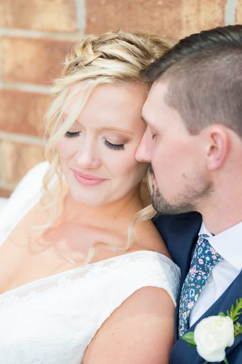 Chatham Station wedding photos by Mikkel Paige Photography from this urban chic beautiful venue in Cary, North Carolina. The bride wore a white tulle v-neck gown and up hair-do with braids and groom a blue suit with custom details for a fall celebration. #mikkelpaige #RaleighWeddingPhotographer #NorthCarolinaWeddings #SouthernWeddings #bridestyle #brideandgroom