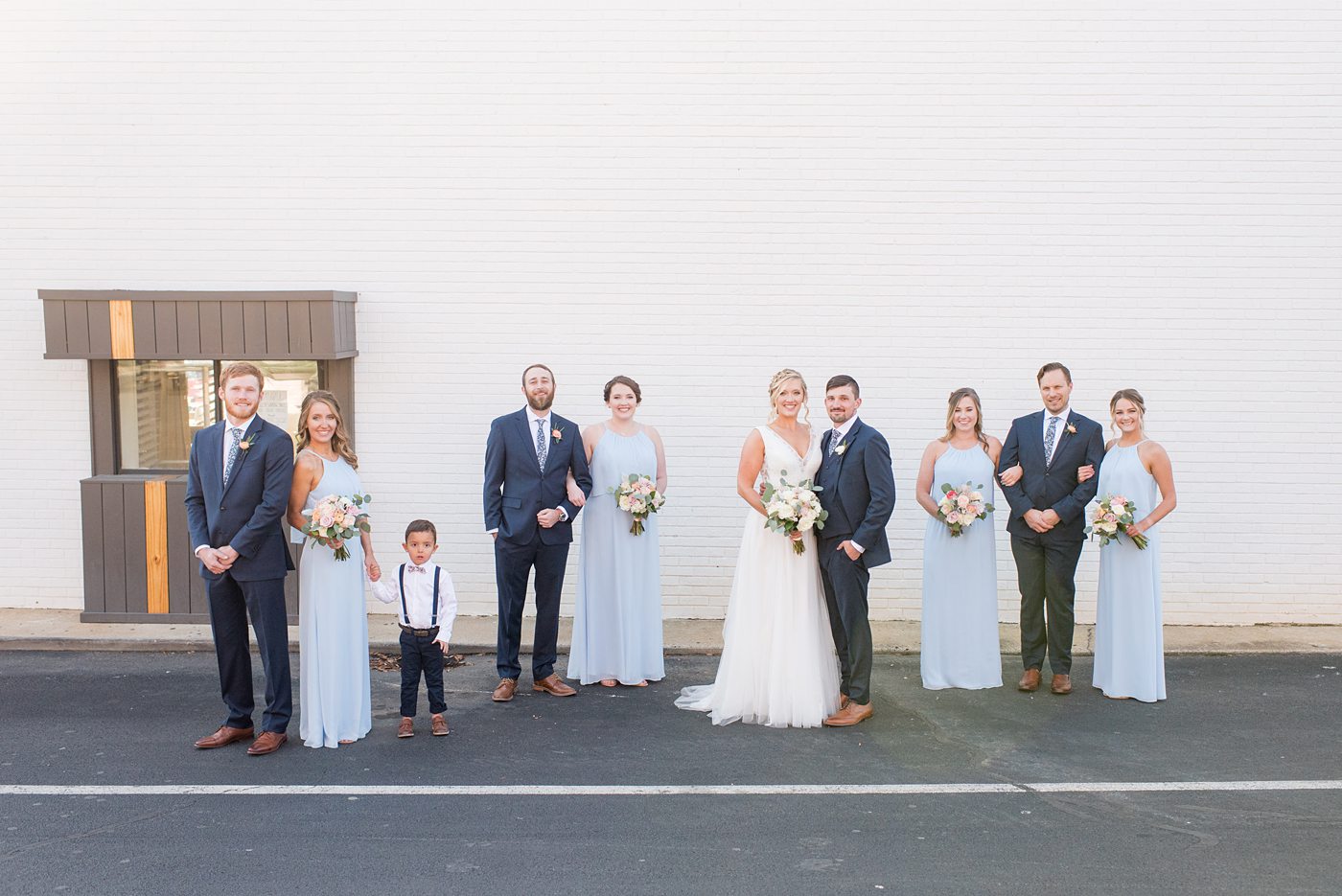 Chatham Station wedding photos by Mikkel Paige Photography from this urban chic beautiful venue in Cary, North Carolina. The bride wore a white tulle v-neck gown, bridesmaids in baby blue gowns and groom and groomsmen in blue suits with custom details for a fall celebration. #mikkelpaige #RaleighWeddingPhotographer #NorthCarolinaWeddings #SouthernWeddings #bridestyle #brideandgroom #bridalparty #lightbluegowns #bluebridesmaids #babybluewedding #lightbluewedding