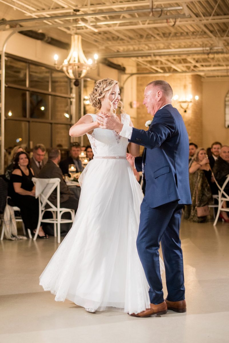 Fall photos at Cary, North Carolina wedding venue Chatham Station by Mikkel Paige Photography. This urban, beautiful space has an indoor and outdoor space near Raleigh. A DJ played as guests looked on during their reception as the bride and father of the bride danced. #mikkelpaige #RaleighWeddingPhotographer #NorthCarolinaWeddings #SouthernWeddings #fallwedding #RaleighWedding #CaryNorthCarolina