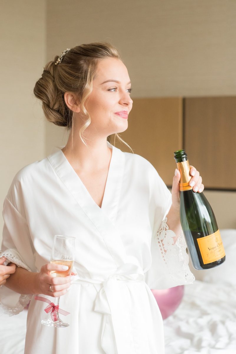 Wedding photographer Mikkel Paige Photography captures a ceremony at Duke Chapel and reception at The Rickhouse, a beautiful downtown venue in Durham, North Carolina. The bride and groom got ready at the JB Duke Hotel. #durhamweddingphotographer #DukeChapelWedding #DurhamWeddingNorthCarolina #DurhamWeddingPhotographer #MikkelPaige #bridestyle #gettingready #champagnebride