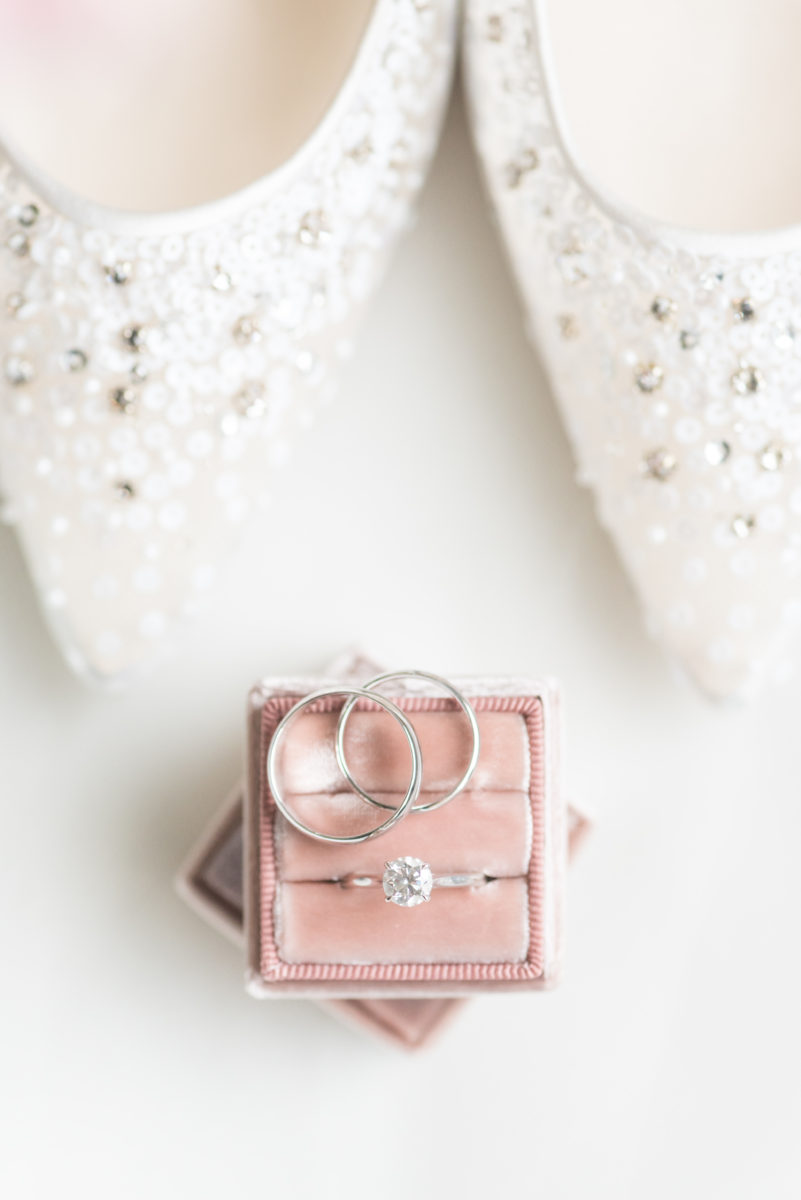 Wedding photographer Mikkel Paige Photography captures a ceremony at Duke Chapel and reception at The Rickhouse, a beautiful downtown venue in Durham, North Carolina. The bride and groom got ready at the JB Duke Hotel. Photo of details of the pearl earrings and bride's high heel shoes. #durhamweddingphotographer #DukeChapelWedding #DurhamWeddingNorthCarolina #DurhamWeddingPhootgrapher #MikkelPaige #bridestyle #theMrsBox