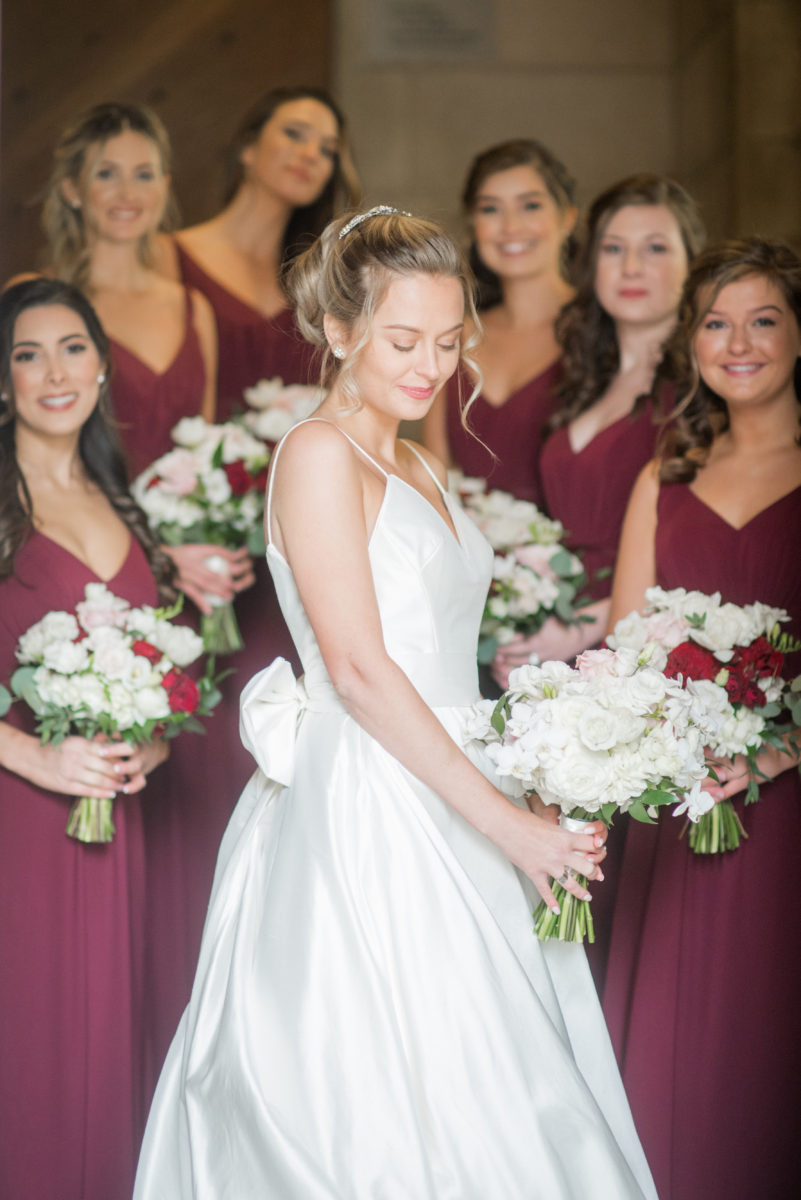 Wedding photographer Mikkel Paige Photography captures a ceremony at Duke Chapel and reception at The Rickhouse, a beautiful downtown venue in Durham, North Carolina. The bridesmaids wore maroon red, chiffon dresses and bride a v-neck white dupioni silk gown. #durhamweddingphotographer #DukeChapelWedding #DurhamWeddingNorthCarolina #DurhamWeddingPhotographer #MikkelPaige #bridesmaids #burgundywedding #maroonwedding