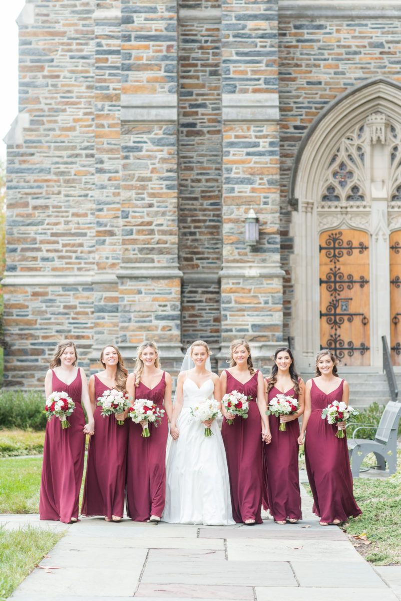 Wedding photographer Mikkel Paige Photography captures a ceremony at Duke Chapel and reception at The Rickhouse, a beautiful downtown venue in Durham, North Carolina. The bridesmaids wore maroon red, chiffon dresses and bride a v-neck white dupioni silk gown. #durhamweddingphotographer #DukeChapelWedding #DurhamWeddingNorthCarolina #DurhamWeddingPhotographer #MikkelPaige #bridesmaids #burgundywedding #maroonwedding