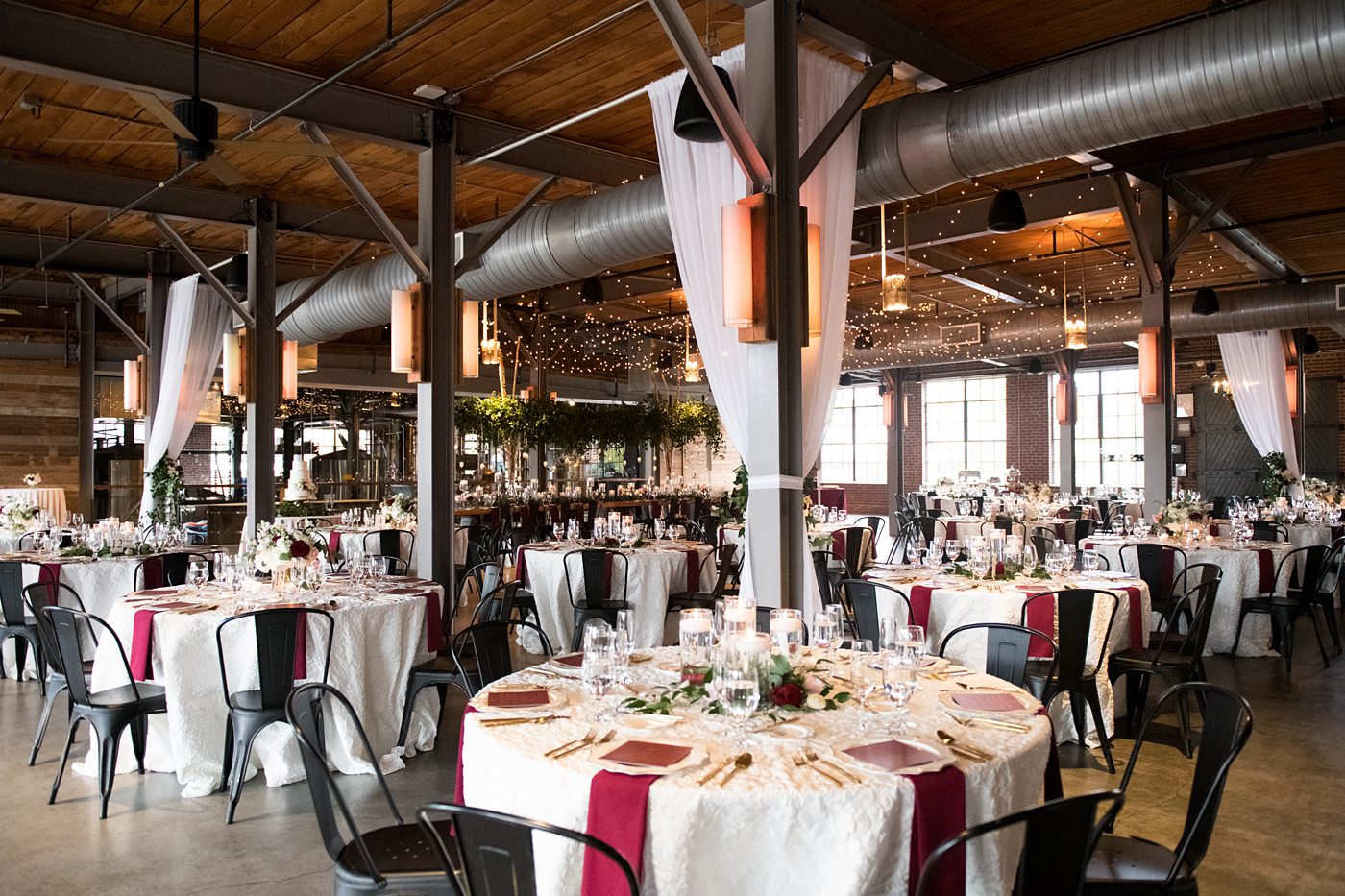 Wedding photographer Mikkel Paige Photography captures a ceremony at Duke Chapel and reception at The Rickhouse, a beautiful downtown Durham, North Carolina. The venue was filled with candlelight and greenery for a maroon and gold color palette wedding. #DukeChapelWedding #DurhamWeddingNorthCarolina #DurhamWeddingPhotographer #MikkelPaige #maroonwedding #fallwedding