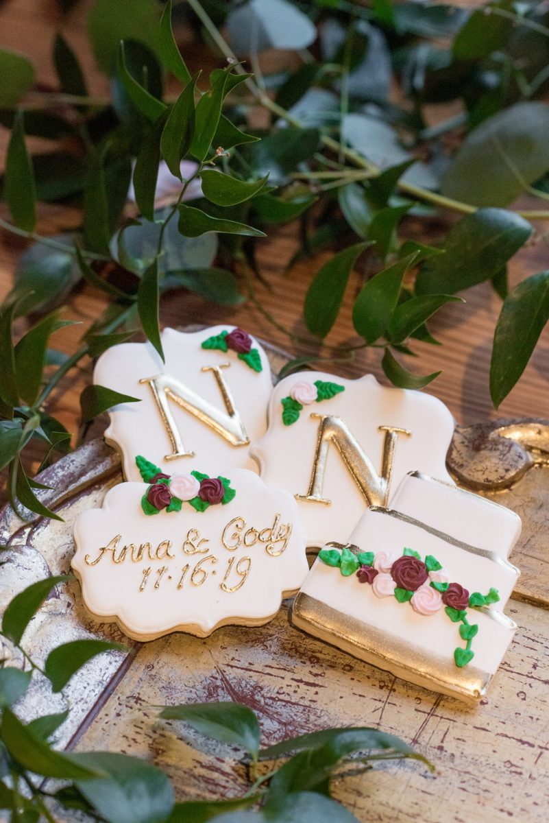 Wedding photographer Mikkel Paige Photography captures a ceremony at Duke Chapel and reception at The Rickhouse, a beautiful downtown Durham, North Carolina. The venue was filled with candlelight and greenery for a maroon and gold color palette wedding. #DukeChapelWedding #DurhamWeddingNorthCarolina #DurhamWeddingPhotographer #MikkelPaige #maroonwedding #fallwedding #weddingcookies #weddingfavors