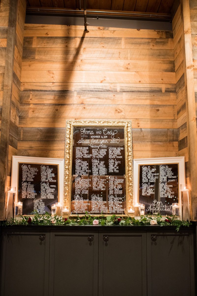 Wedding photographer Mikkel Paige Photography captures a ceremony at Duke Chapel and reception at The Rickhouse, a beautiful downtown Durham, North Carolina. The venue was filled with candlelight and greenery for a maroon and gold color palette wedding. #DukeChapelWedding #DurhamWeddingNorthCarolina #DurhamWeddingPhotographer #MikkelPaige #maroonwedding #fallwedding #mirrorseatingchart