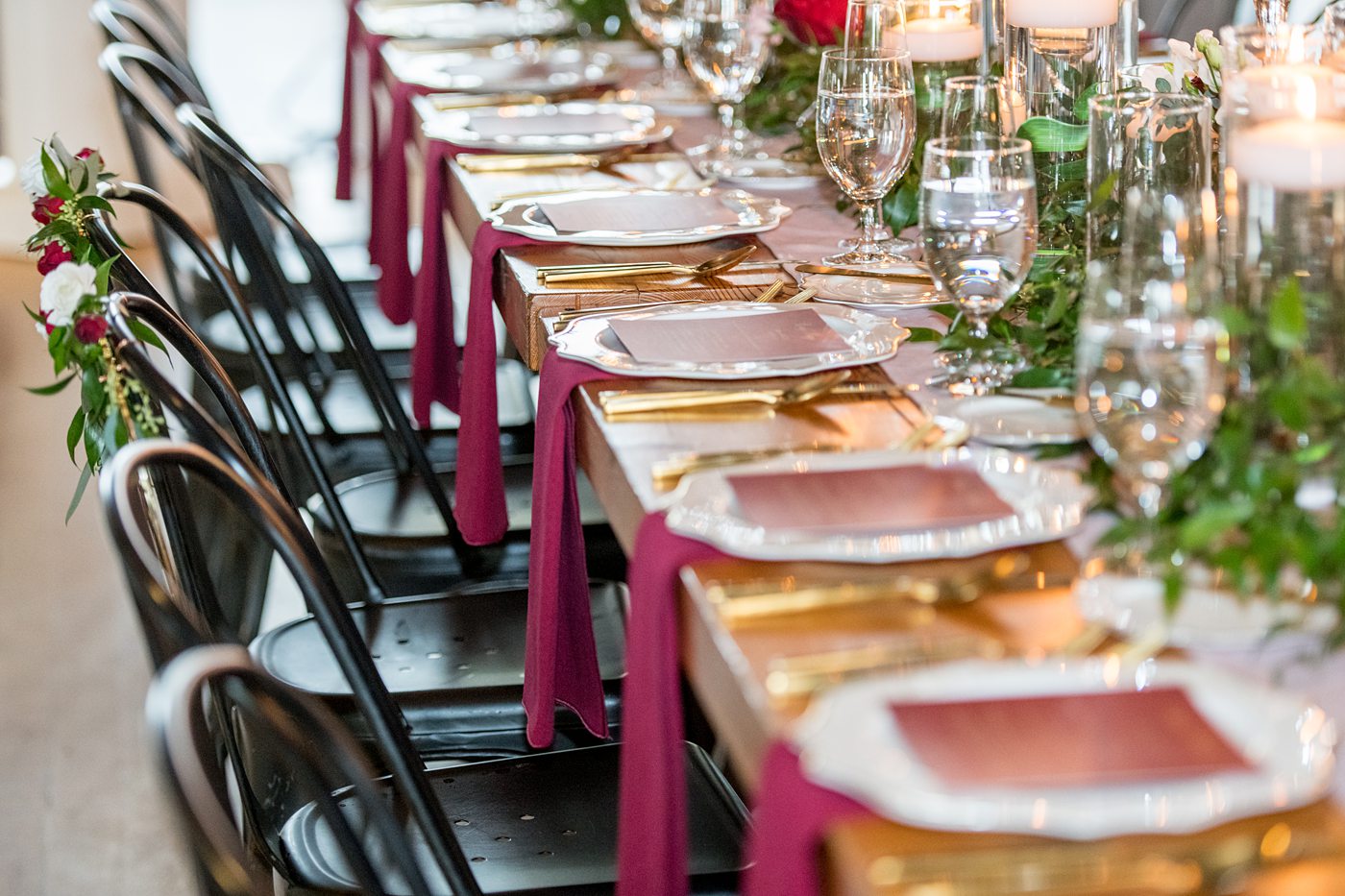 Wedding photographer Mikkel Paige Photography captures a ceremony at Duke Chapel and reception at The Rickhouse, a beautiful downtown Durham, North Carolina. The venue was filled with candlelight and greenery for a maroon and gold color palette wedding. #DukeChapelWedding #DurhamWeddingNorthCarolina #DurhamWeddingPhotographer #MikkelPaige #maroonwedding #fallwedding