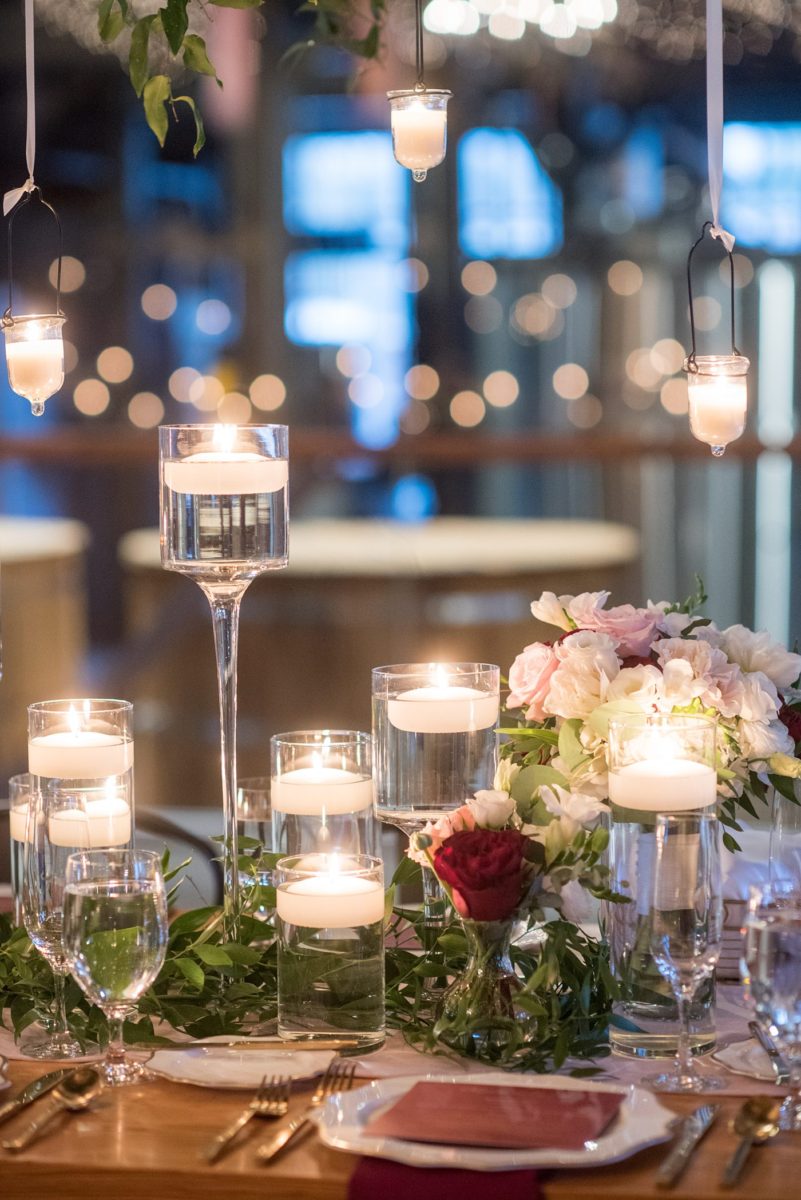 Wedding photographer Mikkel Paige Photography captures a ceremony at Duke Chapel and reception at The Rickhouse, a beautiful downtown Durham, North Carolina. The venue was filled with candlelight and greenery for a maroon and gold color palette wedding. #DukeChapelWedding #DurhamWeddingNorthCarolina #DurhamWeddingPhotographer #MikkelPaige #maroonwedding #fallwedding