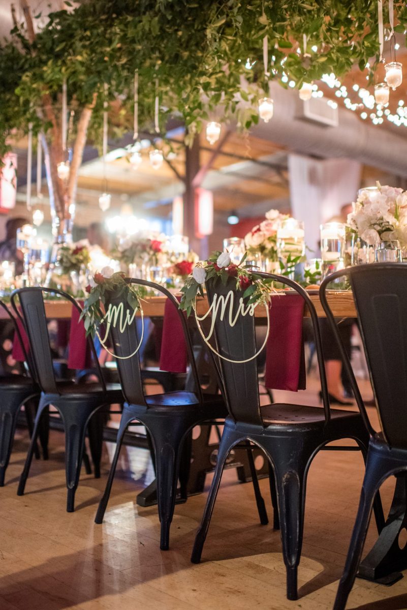 Wedding photographer Mikkel Paige Photography captures a ceremony at Duke Chapel and reception at The Rickhouse, a beautiful downtown Durham, North Carolina. The venue was filled with candlelight and greenery for a maroon and gold color palette wedding. #DukeChapelWedding #DurhamWeddingNorthCarolina #DurhamWeddingPhotographer #MikkelPaige #maroonwedding #fallwedding #mrsandmrschairs