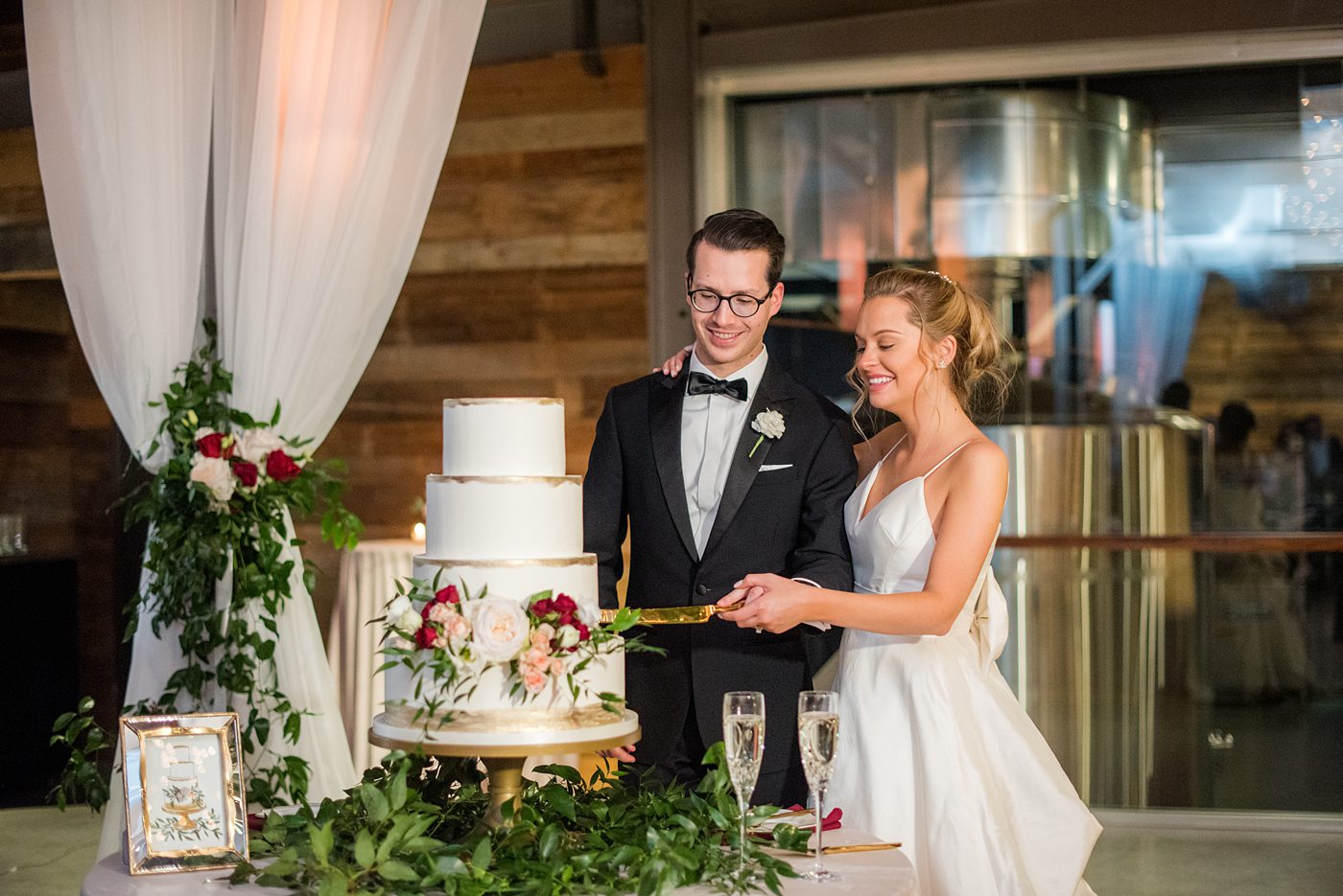 Wedding photographer Mikkel Paige Photography captures a ceremony at Duke Chapel and reception at The Rickhouse, a beautiful downtown Durham, North Carolina. The venue was filled with candlelight and greenery for a maroon and gold color palette wedding. #DukeChapelWedding #DurhamWeddingNorthCarolina #DurhamWeddingPhotographer #MikkelPaige #maroonwedding #fallwedding