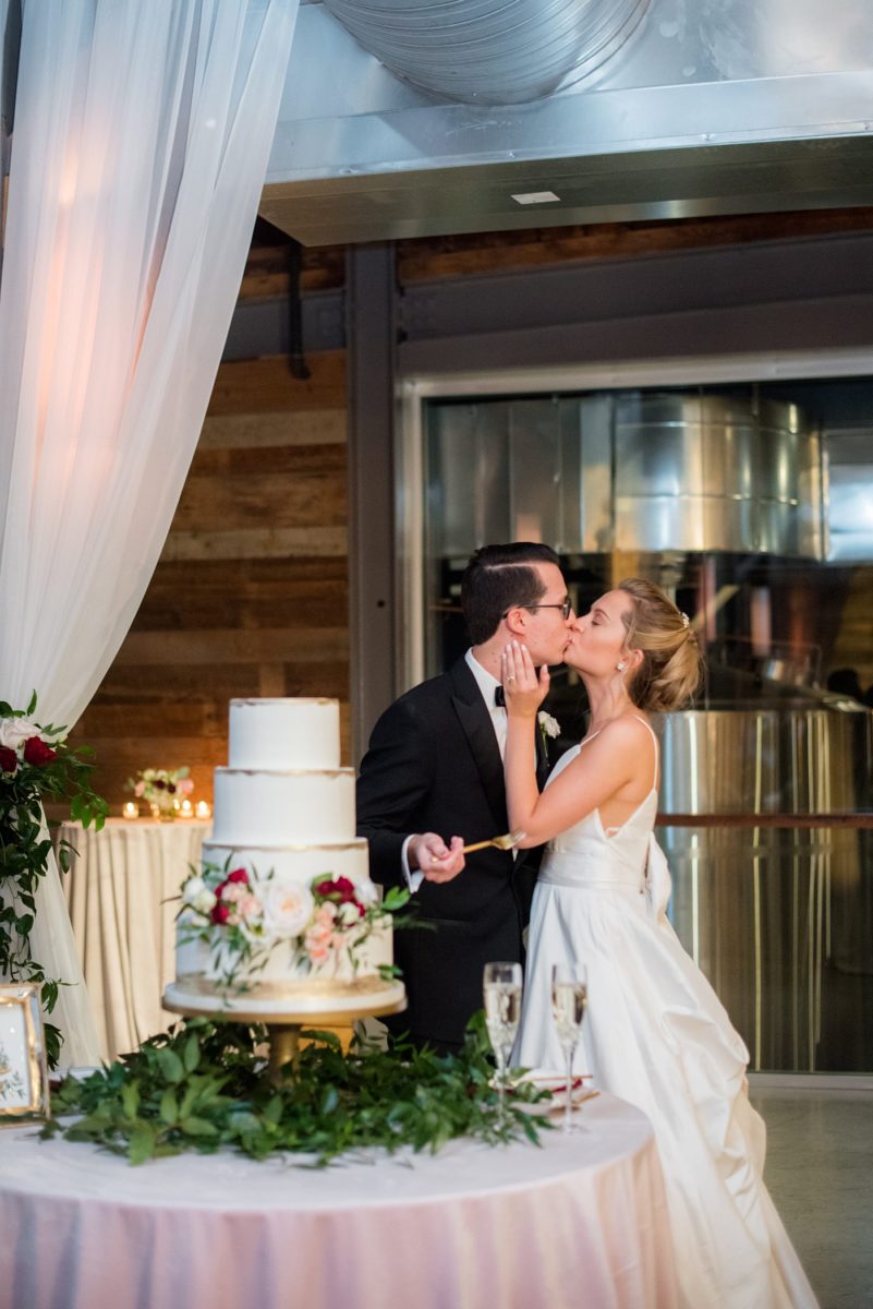 Wedding photographer Mikkel Paige Photography captures a ceremony at Duke Chapel and reception at The Rickhouse, a beautiful downtown Durham, North Carolina. The venue was filled with candlelight and greenery for a maroon and gold color palette wedding. #DukeChapelWedding #DurhamWeddingNorthCarolina #DurhamWeddingPhotographer #MikkelPaige #maroonwedding #fallwedding