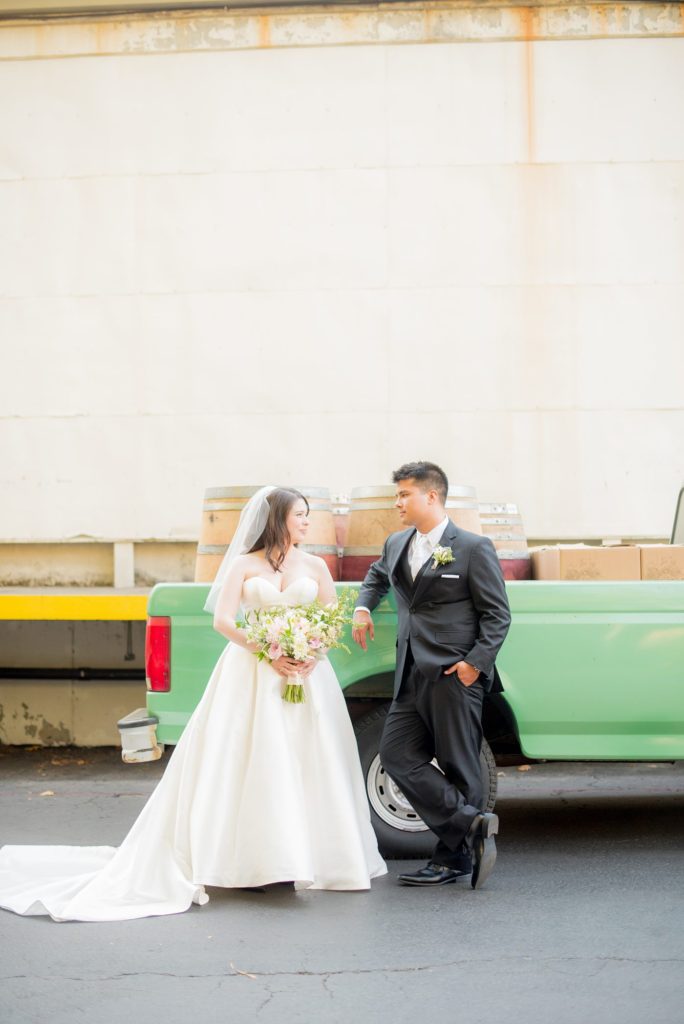 A destination wedding picture with the bride and groom and a vintage mint pickup truck at a California winery in Los Gatos called Testarossa. Photos by Mikkel Paige Photography.