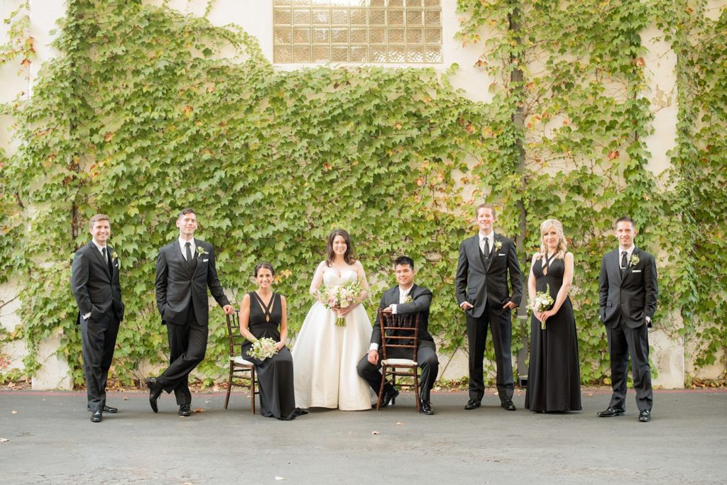 A destination wedding picture with the wedding party in timeless black and white at a California winery in Los Gatos called Testarossa. Photos by Mikkel Paige Photography.
