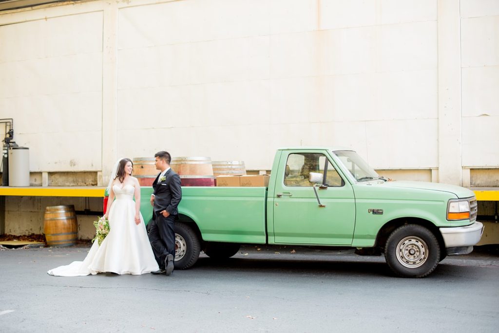 A destination wedding picture with the bride and groom and a vintage mint pickup truck at a California winery in Los Gatos called Testarossa. Photos by Mikkel Paige Photography.