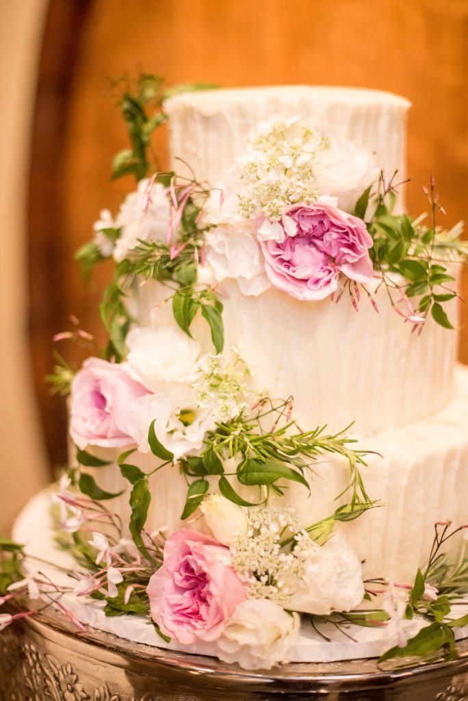 A destination wedding picture of the white and pink tiered cake at a California winery in Los Gatos called Testarossa. Photos by Mikkel Paige Photography.