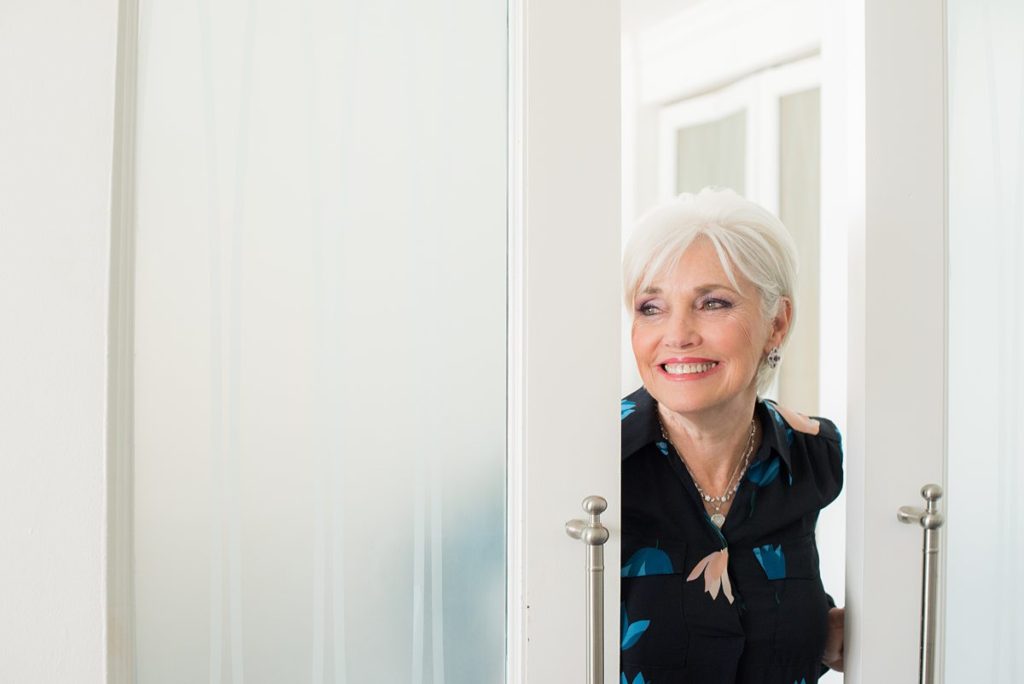 Eau Palm Beach Florida Destination Wedding photos by Mikkel Paige Photography. The mother of the bride looked lovingly at her daughter from the room next door.