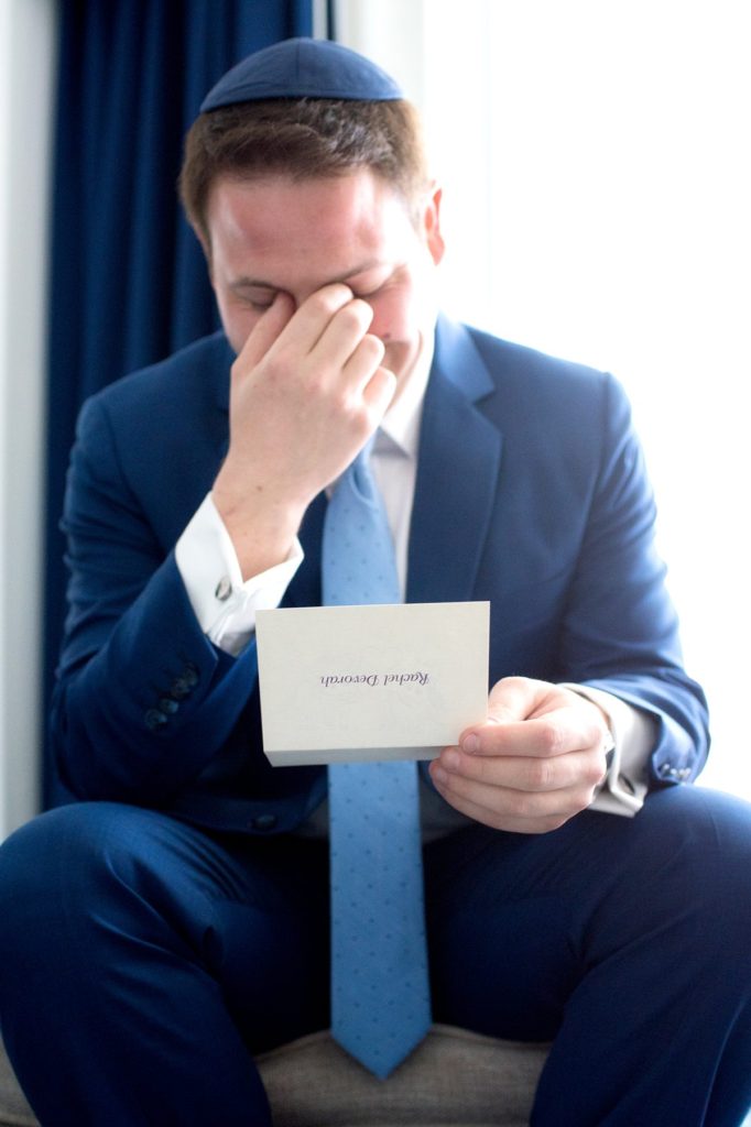 Eau Palm Beach Florida Destination Wedding photos by Mikkel Paige Photography. The groom cries as he reads a note from his bride.