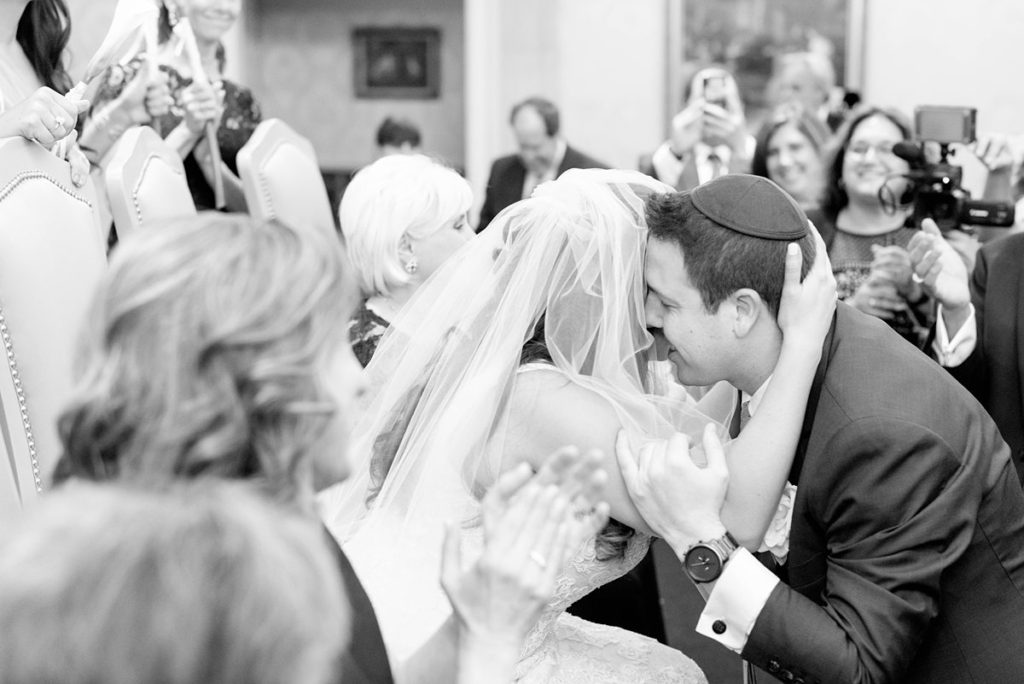 Eau Palm Beach Florida Destination Wedding photos by Mikkel Paige Photography. The bride and groom share an emotional moment during the tish and bedekan.