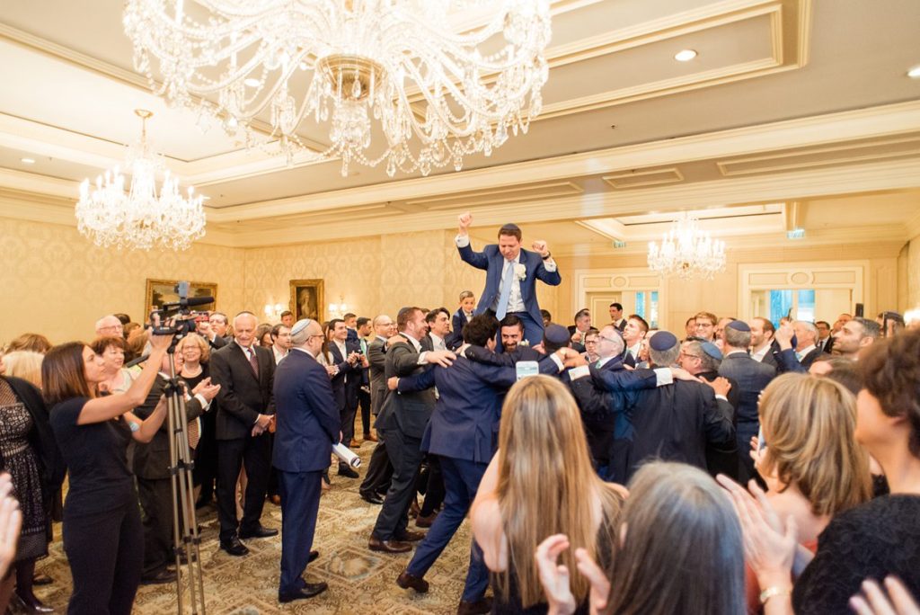 Eau Palm Beach Florida Destination Wedding photos by Mikkel Paige Photography. The groom shows excitement during the tish and bedekan.