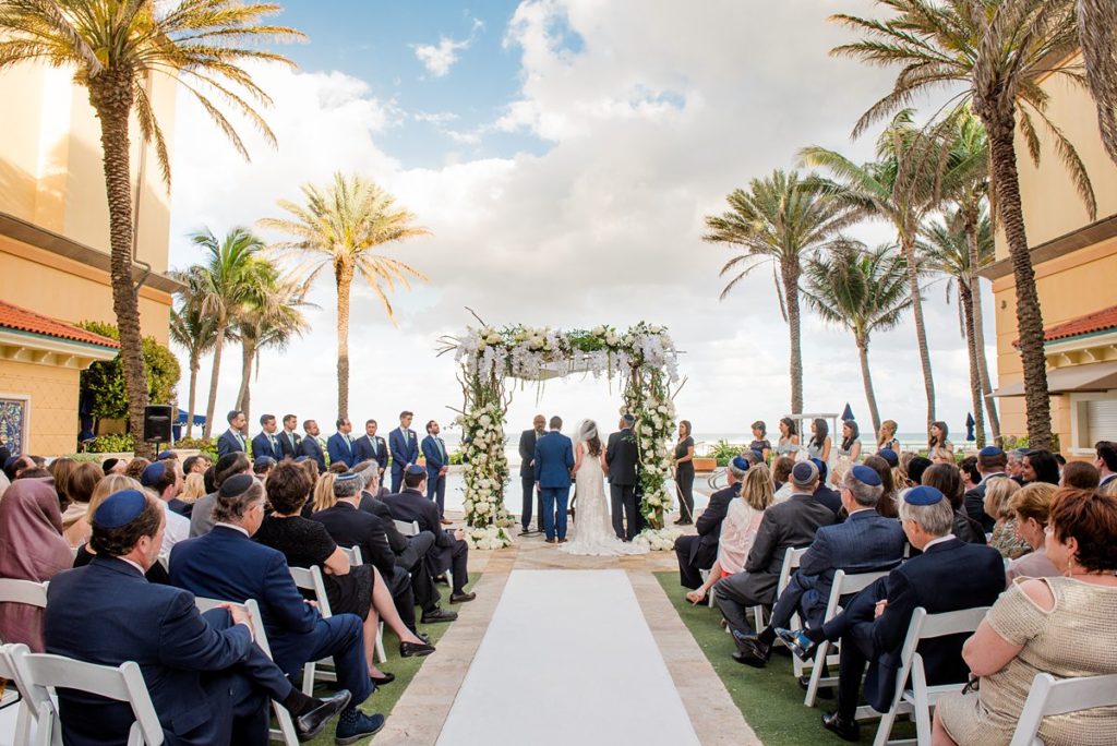 Eau Palm Beach Florida Destination Wedding photos by Mikkel Paige Photography. The Jewish ceremony was held by the pool overlooking the ocean.