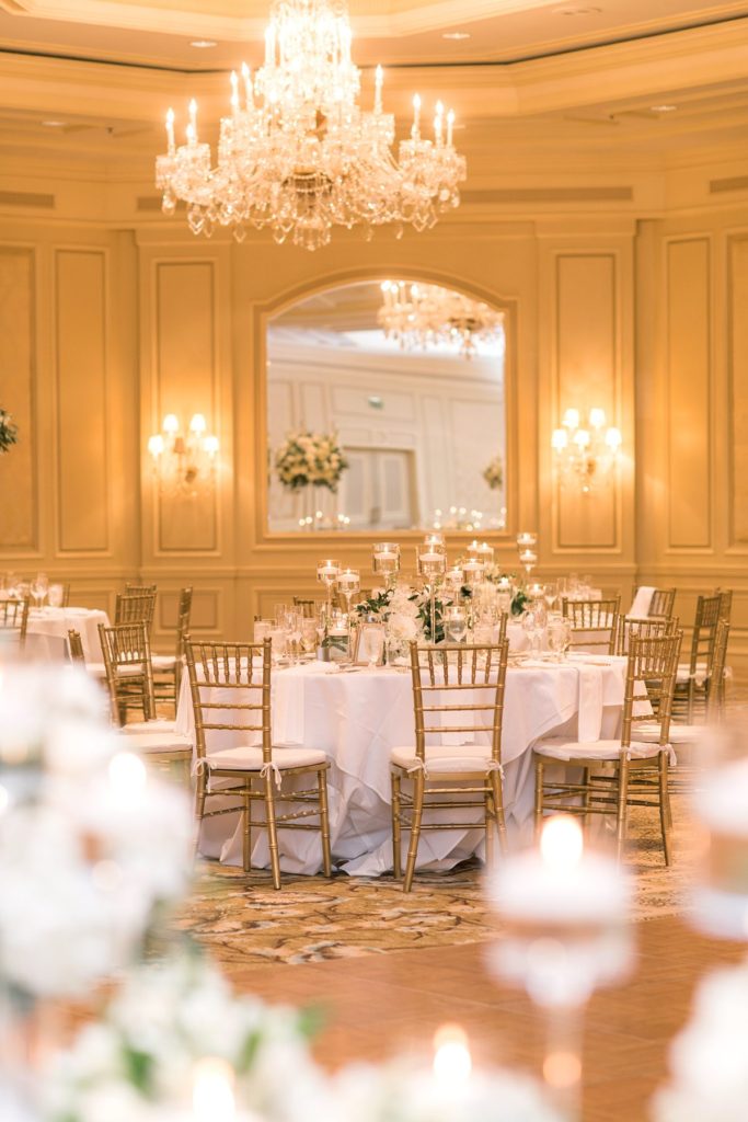 Eau Palm Beach Florida Destination Wedding photos by Mikkel Paige Photography. The luxurious reception was held in the gold ballroom, drenched in white flowers and candlelight.