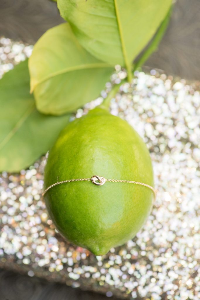 Estancia La Jolla wedding photos of a tie the knot bracelet with destination photographer Mikkel Paige Photography.