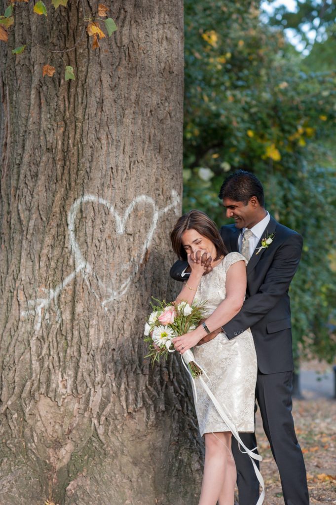 A bride and groom during their small Brooklyn wedding elopement in NYC during Fall. Photos by Mikkel Paige Photography with a ceremony held at Fort Greene Park.
