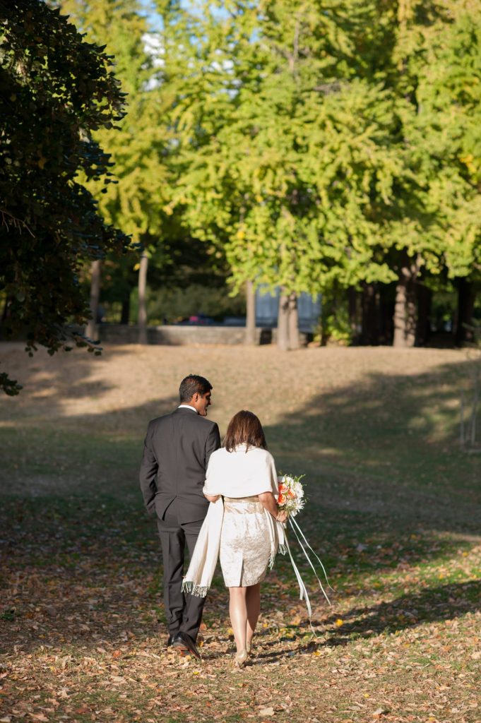 A bride and groom during their small Brooklyn wedding elopement in NYC during Fall. Photos by Mikkel Paige Photography with a ceremony held at Fort Greene Park.