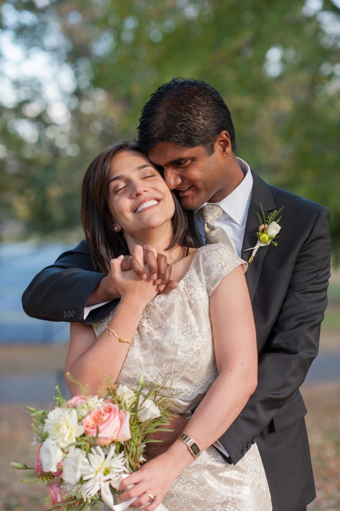 A bride and groom during their small Brooklyn wedding elopement in NYC during Fall. Photos by Mikkel Paige Photography with a ceremony held at Fort Greene Park.