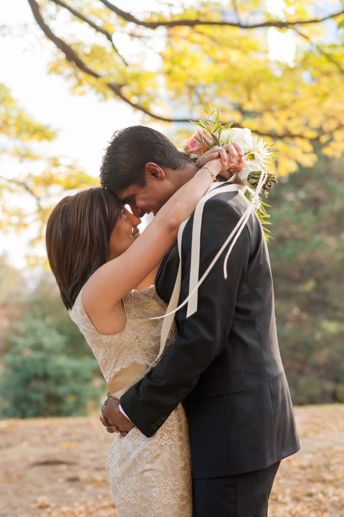 A bride and groom during their small Brooklyn wedding elopement in NYC during Fall. Photos by Mikkel Paige Photography with a ceremony held at Fort Greene Park.