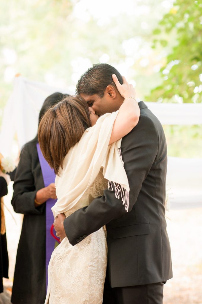 First kiss as a married couple during a small Brooklyn wedding elopement in NYC during Fall. Photos by Mikkel Paige Photography with a ceremony held at Fort Greene Park.