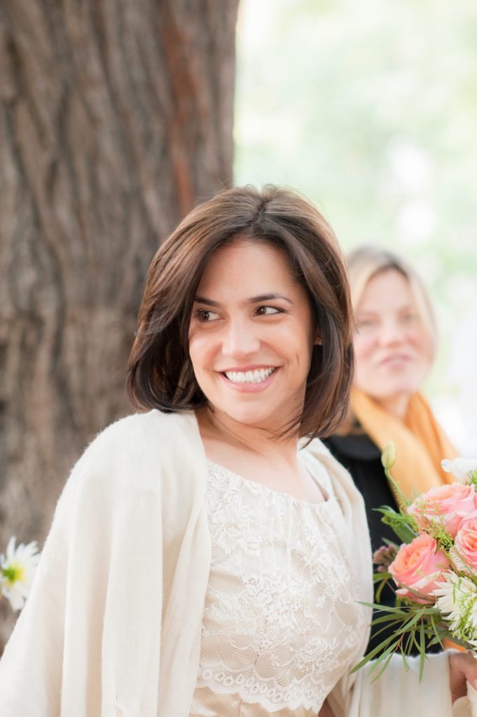 Bride in a short sleeve off white dress during her small Brooklyn wedding elopement in NYC during Fall. Photos by Mikkel Paige Photography with a ceremony held at Fort Greene Park.